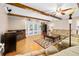 Comfortable living room with hardwood floors, wooden ceiling beams, and access to the backyard pool at 19 Twin River Dr, Ormond Beach, FL 32174