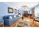 Spacious living room featuring a comfortable blue sofa, classic decor, and an open layout at 19 Twin River Dr, Ormond Beach, FL 32174