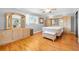 Bright main bedroom with light wood floors and custom-built in cabinets and dresser with mirror at 19 Twin River Dr, Ormond Beach, FL 32174