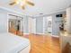 Bright main bedroom featuring hardwood floors, mirrored closet doors, and ensuite bathroom access at 19 Twin River Dr, Ormond Beach, FL 32174