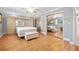 Spacious main bedroom featuring built-in cabinets, a large bed, and mirrored closet doors at 19 Twin River Dr, Ormond Beach, FL 32174