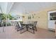 Covered outdoor patio with dining table and chairs, ideal for entertaining at 19 Twin River Dr, Ormond Beach, FL 32174