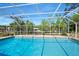 Enclosed pool area with bright blue water surrounded by a white screen enclosure at 19 Twin River Dr, Ormond Beach, FL 32174