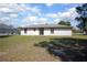 Spacious backyard with green grass, showing the back of the home at 2017 Monterey Dr, Deltona, FL 32738