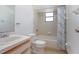 Bathroom with tiled shower/tub, toilet, sink, and wood-trimmed vanity at 2017 Monterey Dr, Deltona, FL 32738