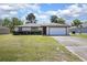 Charming single-story home with a well-manicured lawn and attached two-car garage at 2017 Monterey Dr, Deltona, FL 32738