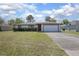 Charming single-story home with a well-manicured lawn and attached two-car garage at 2017 Monterey Dr, Deltona, FL 32738