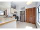 Functional kitchen with stainless steel appliances and a breakfast bar overlooking the dining room at 2017 Monterey Dr, Deltona, FL 32738