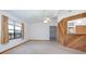 Bright living room with a ceiling fan, and a rustic wood breakfast bar facing the kitchen at 2017 Monterey Dr, Deltona, FL 32738