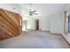 Bright living room with a ceiling fan, and a rustic wood breakfast bar facing the kitchen at 2017 Monterey Dr, Deltona, FL 32738