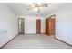 Spacious main bedroom featuring neutral carpet, a ceiling fan, and double closets at 2017 Monterey Dr, Deltona, FL 32738