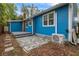 Backyard featuring a small deck, patio area, and the exterior of the home with AC unit at 205 Mary Ave, New Smyrna Beach, FL 32168