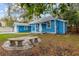 Spacious backyard showcasing a stone patio and bench seating, perfect for outdoor gatherings at 205 Mary Ave, New Smyrna Beach, FL 32168