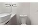 Modern bathroom with a vessel sink, toilet, and minimalist fixtures against a white backdrop at 205 Mary Ave, New Smyrna Beach, FL 32168