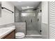 Bathroom featuring modern shower with glass enclosure, light fixtures, and gray tiling at 205 Mary Ave, New Smyrna Beach, FL 32168