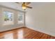 Bedroom featuring hardwood floors, a ceiling fan, and two windows that let in natural light at 205 Mary Ave, New Smyrna Beach, FL 32168