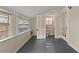 Bright bedroom features gray floors and an open doorway to a half bathroom at 205 Mary Ave, New Smyrna Beach, FL 32168
