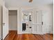 Bedroom featuring hardwood floors and open doorways to a bathroom and what appears to be a closet at 205 Mary Ave, New Smyrna Beach, FL 32168