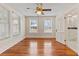 Bright bedroom with hardwood floors, a ceiling fan, and an attached bathroom at 205 Mary Ave, New Smyrna Beach, FL 32168