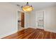 Dining room with hardwood floors, modern light fixture and doorway to a possible butler's pantry at 205 Mary Ave, New Smyrna Beach, FL 32168