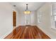 Elegant dining room featuring hardwood floors and a stylish chandelier, creating a refined ambiance at 205 Mary Ave, New Smyrna Beach, FL 32168