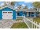 Charming home featuring a garage, white picket fence, and welcoming curb appeal at 205 Mary Ave, New Smyrna Beach, FL 32168