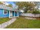 Charming front yard with a stone patio and bench at 205 Mary Ave, New Smyrna Beach, FL 32168