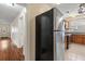Hallway with wooden floors and a black and silver refrigerator at 205 Mary Ave, New Smyrna Beach, FL 32168