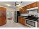 Traditional kitchen with wooden cabinetry, stainless steel appliances, and tile floors at 205 Mary Ave, New Smyrna Beach, FL 32168