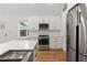 Modern kitchen featuring stainless appliances, white cabinets and countertop, plus wood floors at 205 Mary Ave, New Smyrna Beach, FL 32168