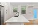 Bright kitchen featuring a modern island, sleek faucet, and stainless steel appliances at 205 Mary Ave, New Smyrna Beach, FL 32168