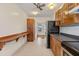 Traditional kitchen with wooden cabinetry, stainless steel appliances, and tile floors at 205 Mary Ave, New Smyrna Beach, FL 32168