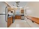 Traditional kitchen with wooden cabinetry, stainless steel appliances, and tiled floors at 205 Mary Ave, New Smyrna Beach, FL 32168