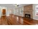 Spacious living room with hardwood floors, a stone fireplace, and natural light at 205 Mary Ave, New Smyrna Beach, FL 32168