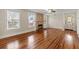 Sunlit living room with gleaming hardwood floors and a stone fireplace, perfect for entertaining at 205 Mary Ave, New Smyrna Beach, FL 32168