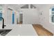 Open living area featuring wood floors, white shiplap walls, lots of windows and natural light at 205 Mary Ave, New Smyrna Beach, FL 32168