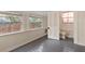 Inviting room with two large windows, neutral walls, and views into a bathroom at 205 Mary Ave, New Smyrna Beach, FL 32168