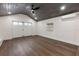 Minimalist room with wood ceiling highlighting a spacious area with window and large white double doors at 205 Mary Ave, New Smyrna Beach, FL 32168
