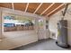 Bright sunroom with wood plank ceiling, neutral walls, and large windows offering natural light and views of the outside at 205 Mary Ave, New Smyrna Beach, FL 32168
