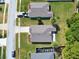 An aerial view shows well-maintained homes with lush green lawns and neatly landscaped gardens at 209 Oak Branch Drive, Edgewater, FL 32141