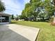 Spacious backyard with a concrete patio and views of lush greenery at 209 Oak Branch Drive, Edgewater, FL 32141