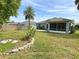 Well-maintained backyard with a privacy fence and a screened patio at 209 Oak Branch Drive, Edgewater, FL 32141