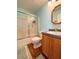 Cozy bathroom features a shower-tub combo, wooden vanity, and wood-look floors at 209 Oak Branch Drive, Edgewater, FL 32141