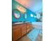Well-appointed bathroom with dual sinks, oak cabinets, a large mirror, and a soaking tub for relaxation at 209 Oak Branch Drive, Edgewater, FL 32141