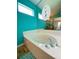 Relaxing bathroom with a clean white tub, chrome fixtures, and a decorative mirror detail enhancing the space at 209 Oak Branch Drive, Edgewater, FL 32141