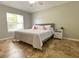 Comfortable bedroom filled with natural light, featuring stylish flooring, a plush bed, and modern furnishings at 209 Oak Branch Drive, Edgewater, FL 32141