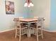 Cozy dining area showcases a stylish chandelier and a decorative table set for four, perfect for intimate meals at 209 Oak Branch Drive, Edgewater, FL 32141