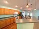 Well-equipped kitchen features stainless steel appliances, wood cabinetry, and an extended counter for casual dining and food preparation at 209 Oak Branch Drive, Edgewater, FL 32141
