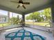 Relaxing screened patio with a ceiling fan and decorative area rug at 209 Oak Branch Drive, Edgewater, FL 32141
