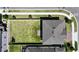 A high-angle aerial view of a gray home shows the size of the grassy back yard and neighborhood around it at 2090 Prairie Sage Ln, Longwood, FL 32750